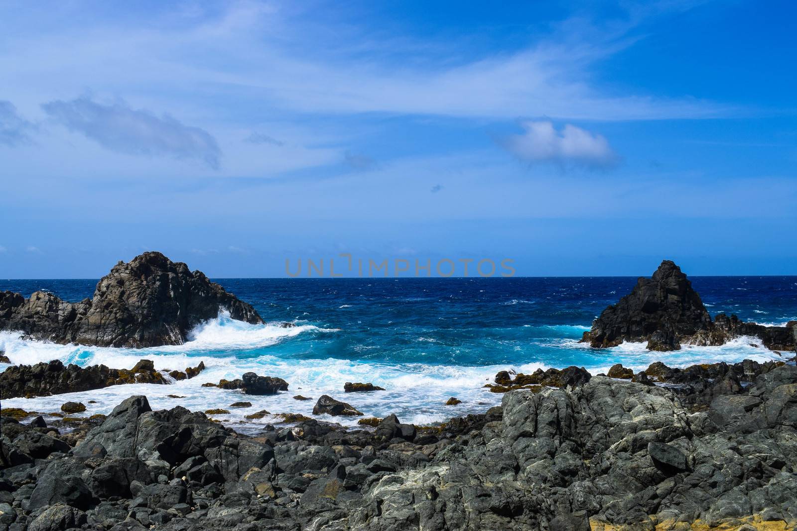 Arikok Natural Park on the island of Aruba in the Caribbean Sea with deserts and ocean waves on the rocky coast