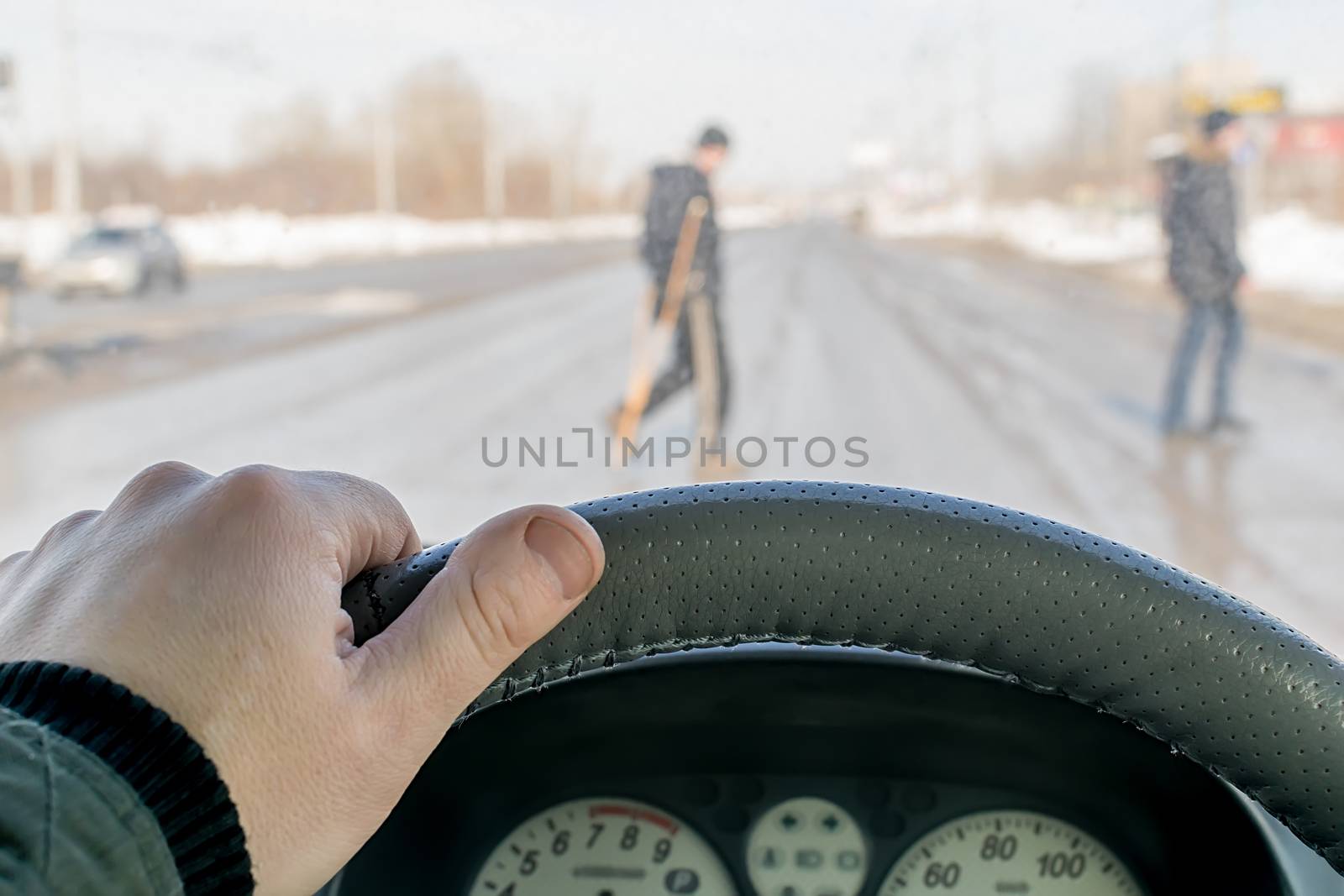 a driver hand on the steering wheel of a car by jk3030