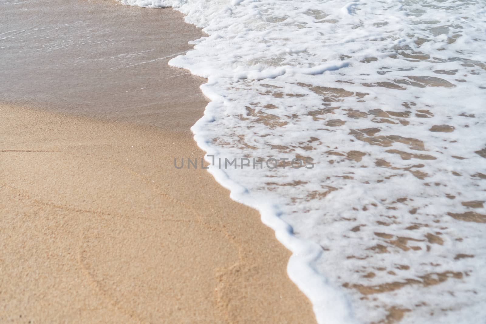 Top view of sand and water clean beach and white sand in summer with sun light blue sky and bokeh background. by Suwant