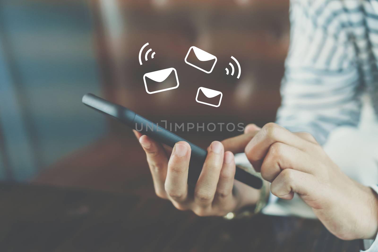 Woman hand using smartphone to send and recieve email. by Suwant