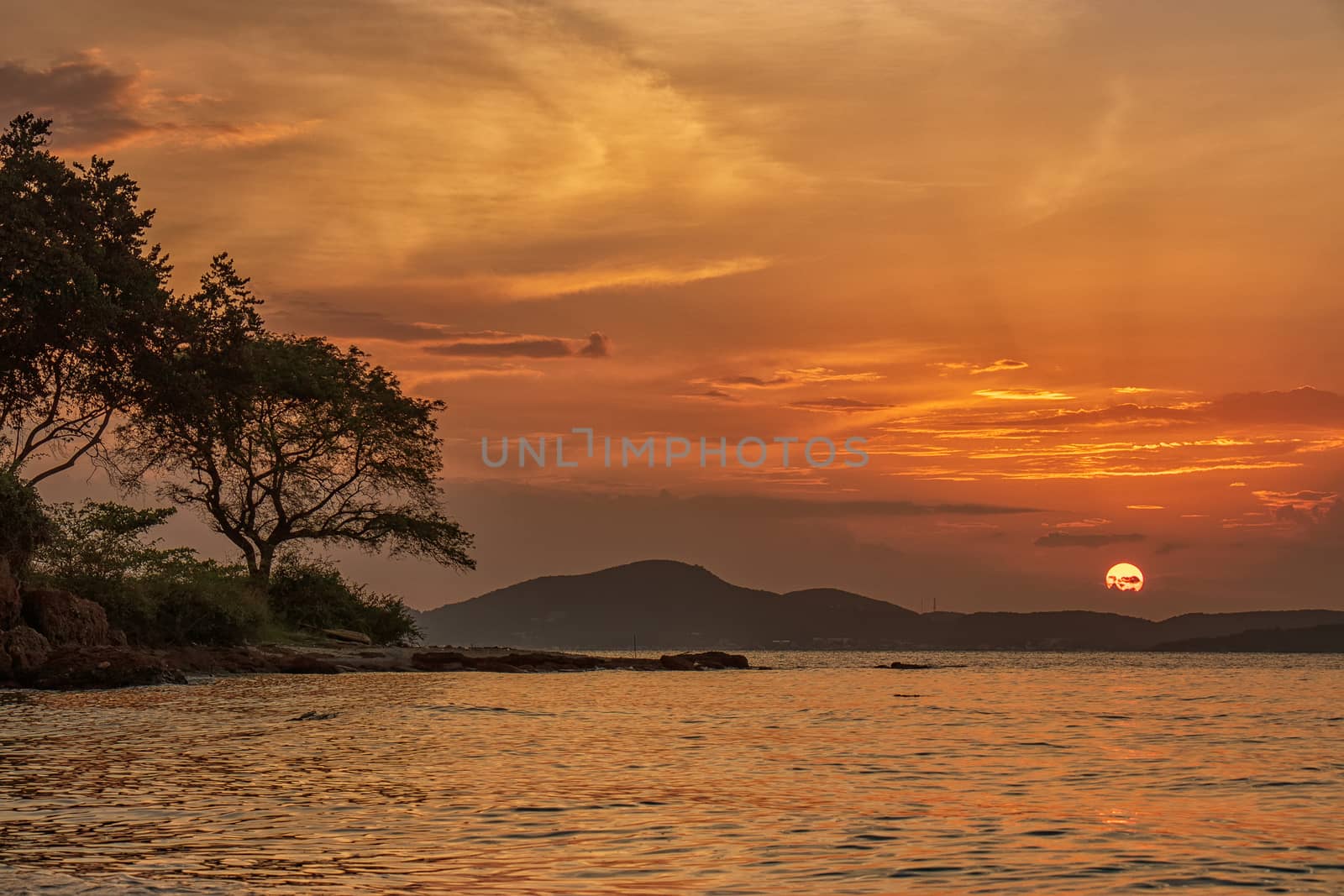 beautiful sunset above the sea at tropical beach by asiandelight