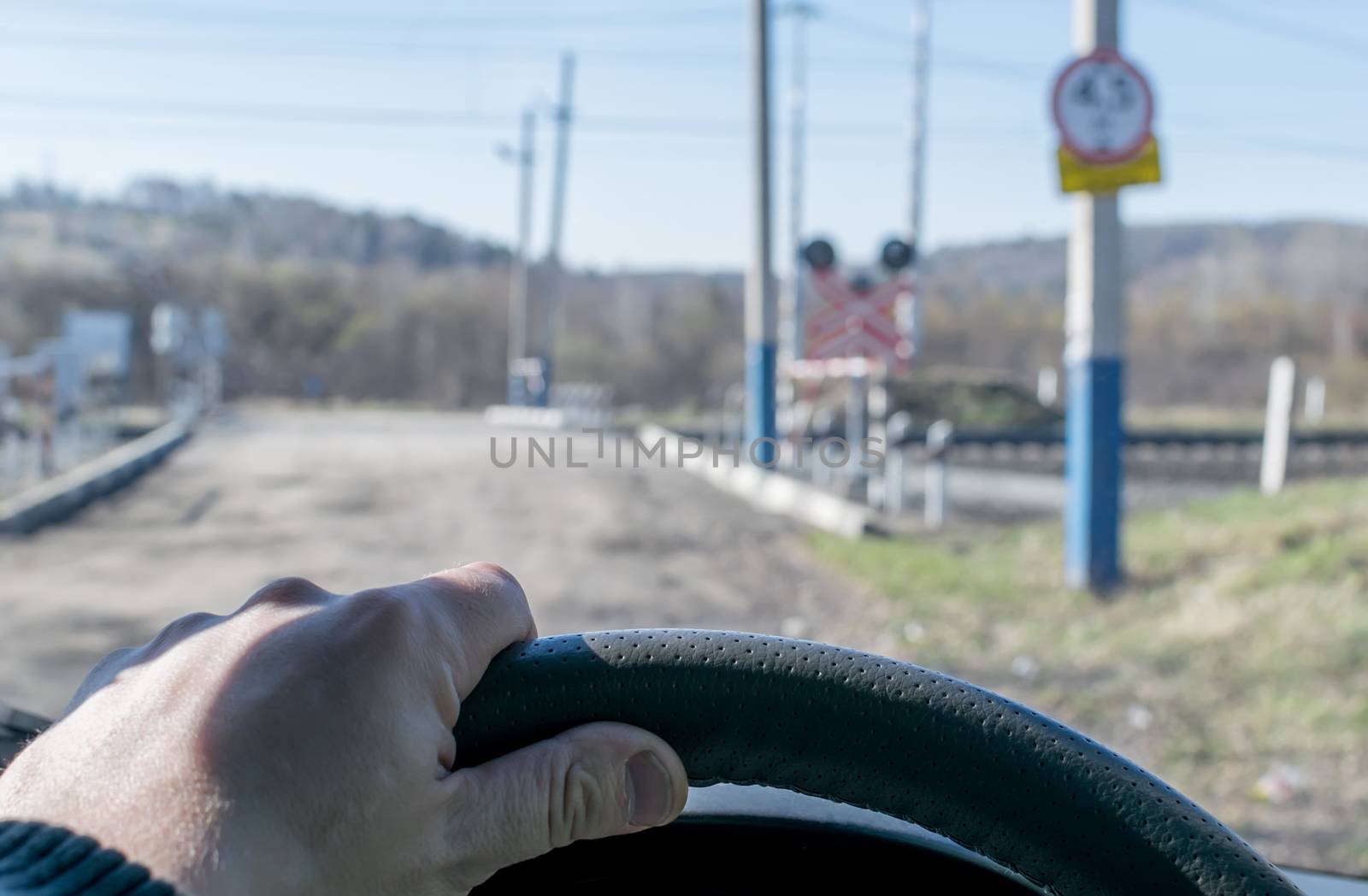 driver hand on the steering wheel of the car by jk3030