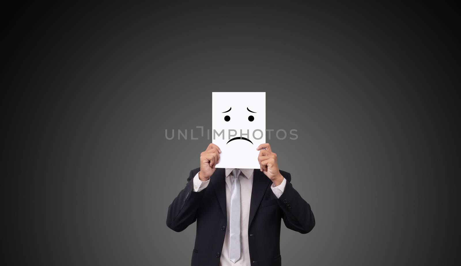 businessman wearing suit with drawing facial expressions emotions feelings on white paper by asiandelight