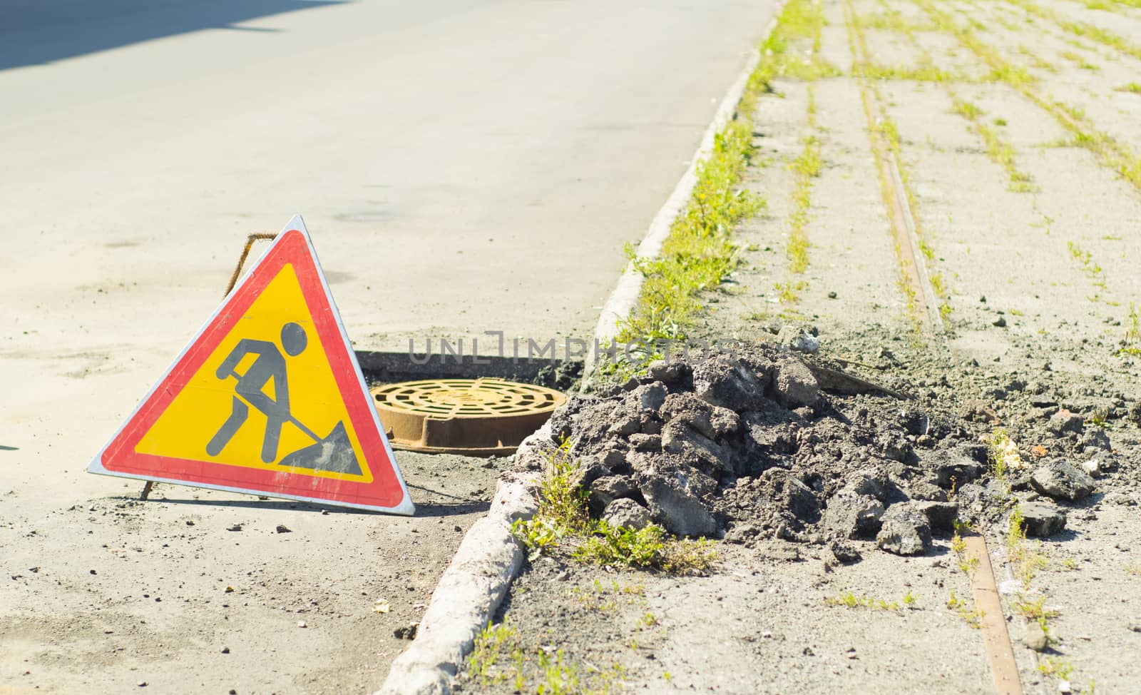 signs of road repair and sidewalk