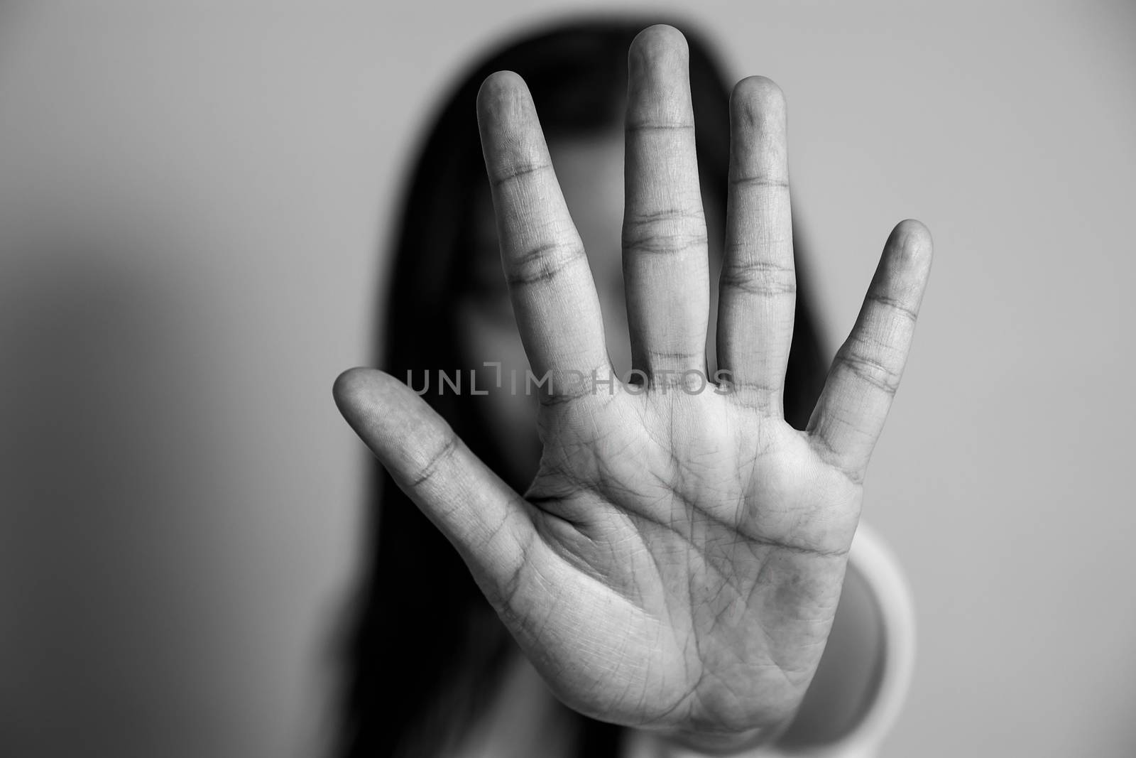 woman raised her hand for dissuade, campaign stop violence against women. Asian woman raised her hand for dissuade with copy space, black and white color by asiandelight