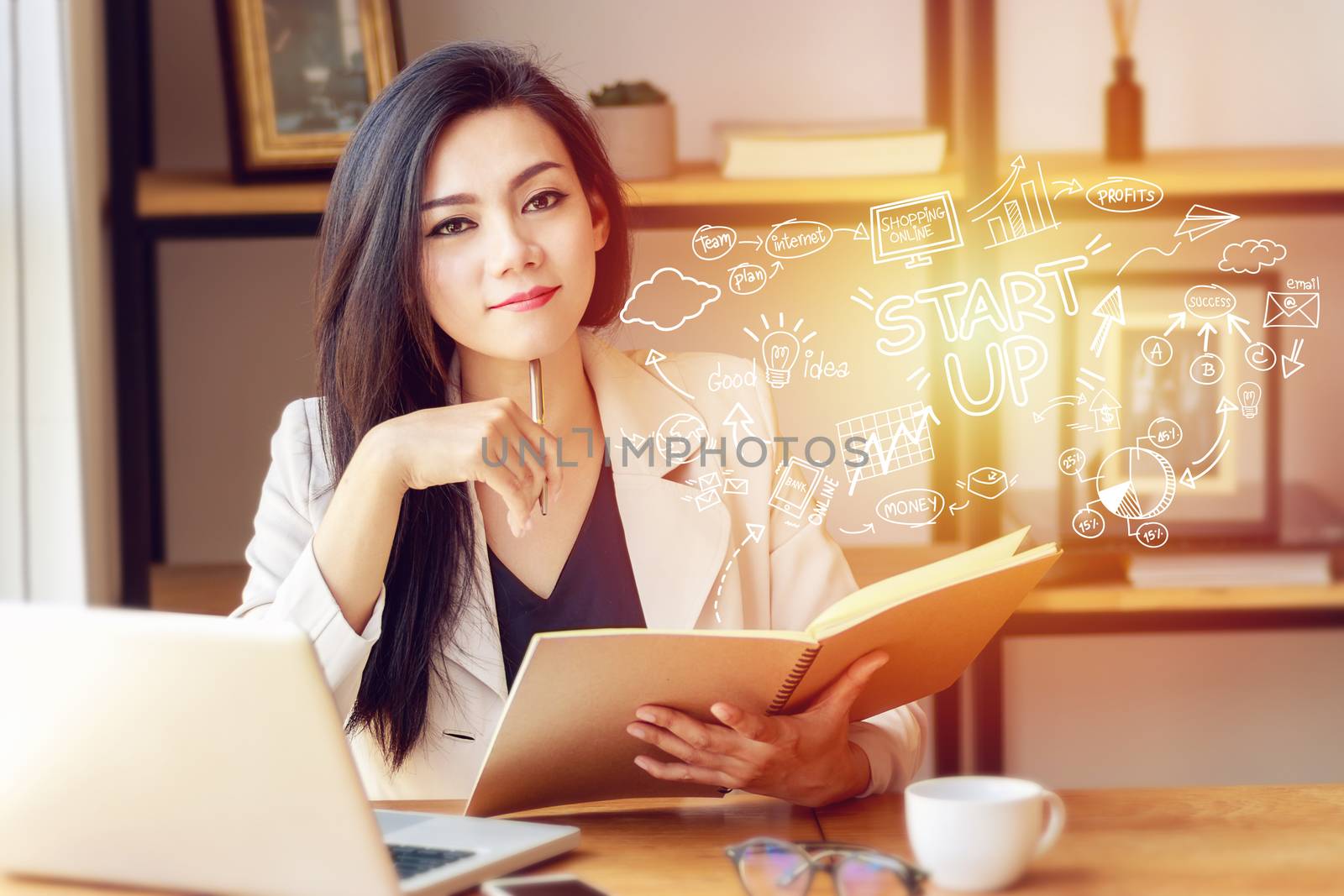 portrait of beautiful and confident Asian business woman in working with notebook laptop and book manage job work at workplace with startup business plan in foreground by asiandelight