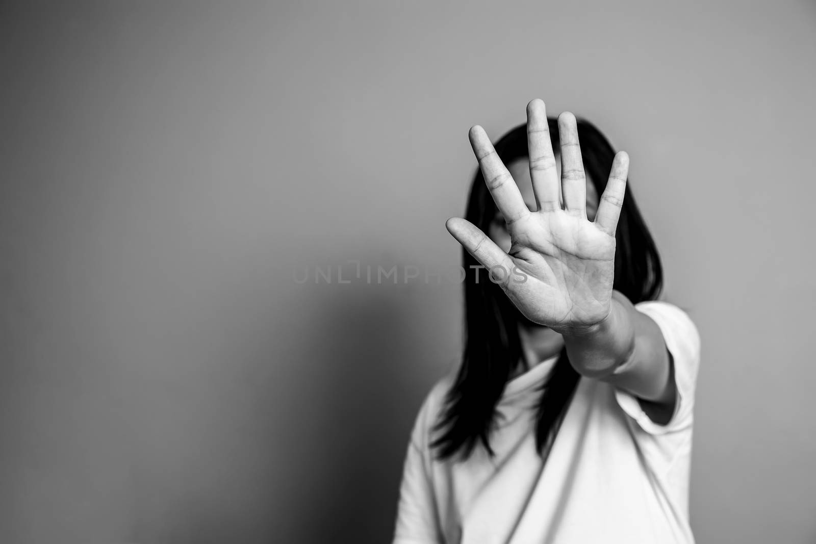 woman raised her hand for dissuade, campaign stop violence against women. Asian woman raised her hand for dissuade with copy space, black and white color by asiandelight