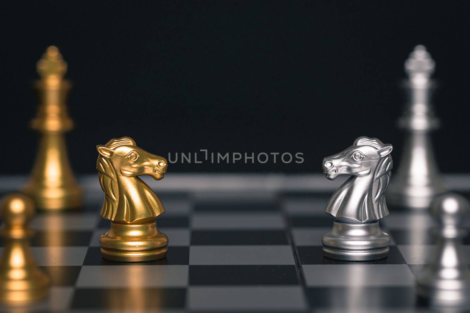 Chess of silver and gold horses face each other in a chess game detail object art