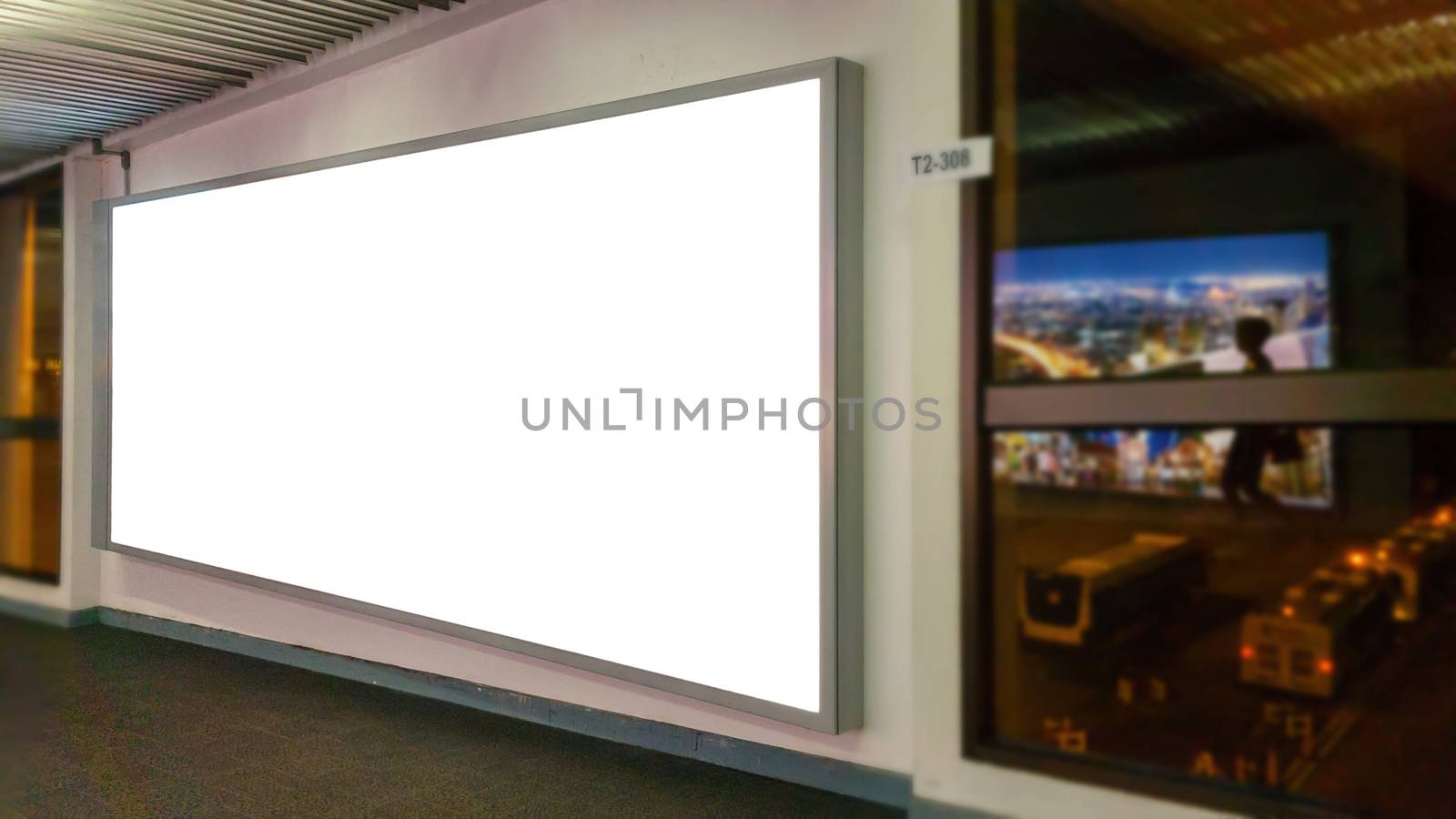 white blank billboard with copy space for your text message or content, advertising mock up banner at the airport, public information board with big window glass for airport view