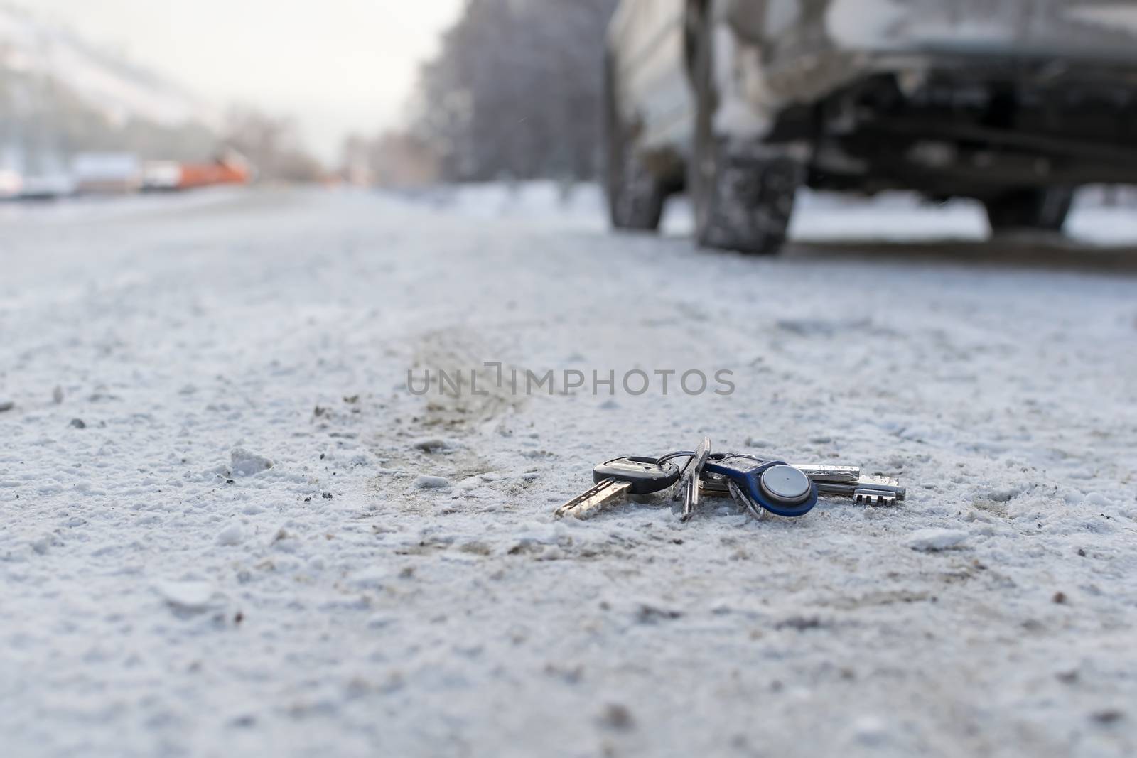 Lost a bunch of keys lying on the side of the road in the winter on the snow, near the roadway