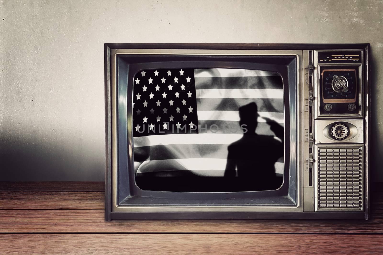 silhouette of soldier on american flag in vintage television on wooden table. Independence day , National american holiday.