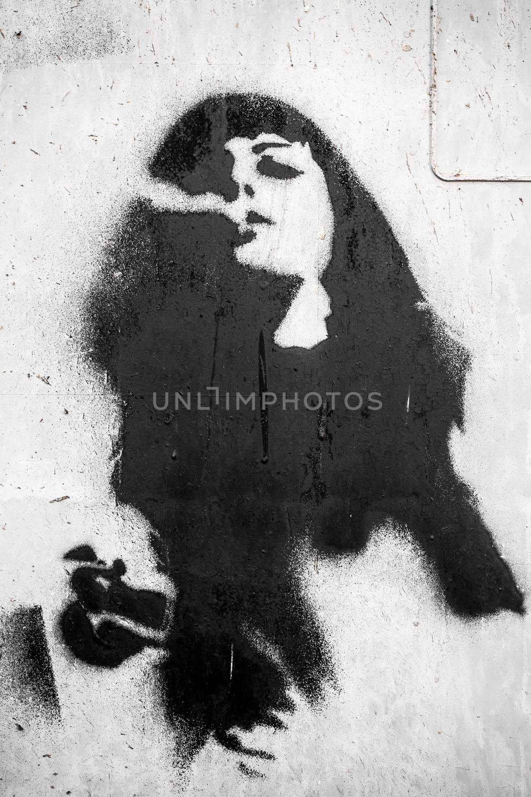 Graffiti on the wall of a woman who smokes.