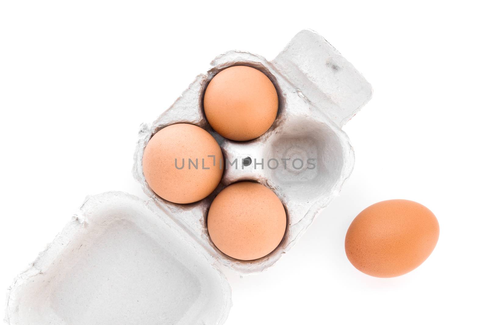 Four eggs in a cardboard egg carton.