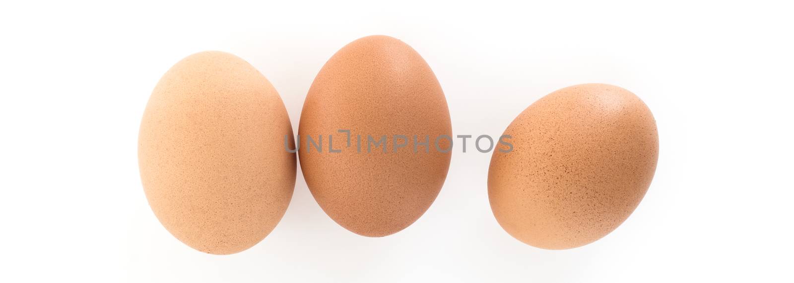 Three eggs photographed from above and isolated on white background.