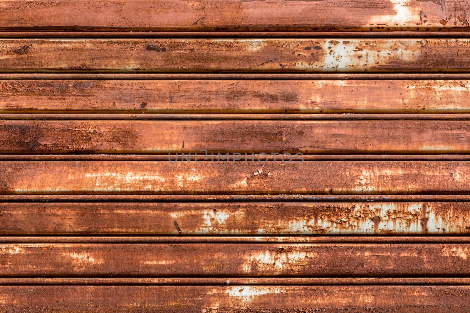 Front view of a shutter rusted, deteriorated from elements.