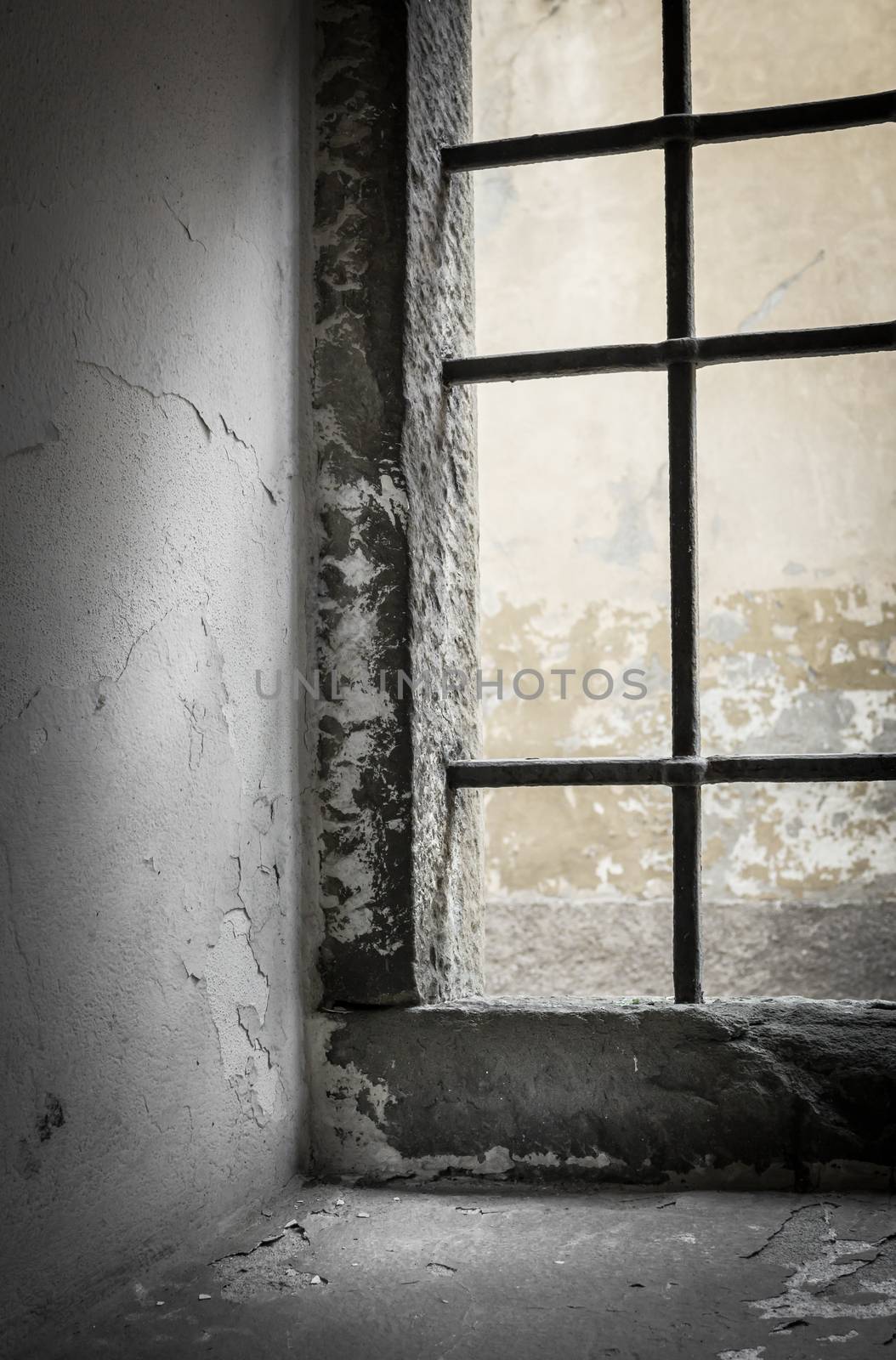 Contrasting light shines through the window of abandoned house. Shallow DOF.