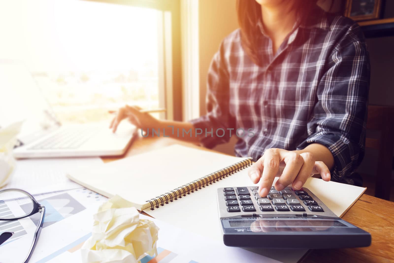 business woman using calculator in office for calculate accounting and financial as accountant job. close up at finger on calculator by asiandelight