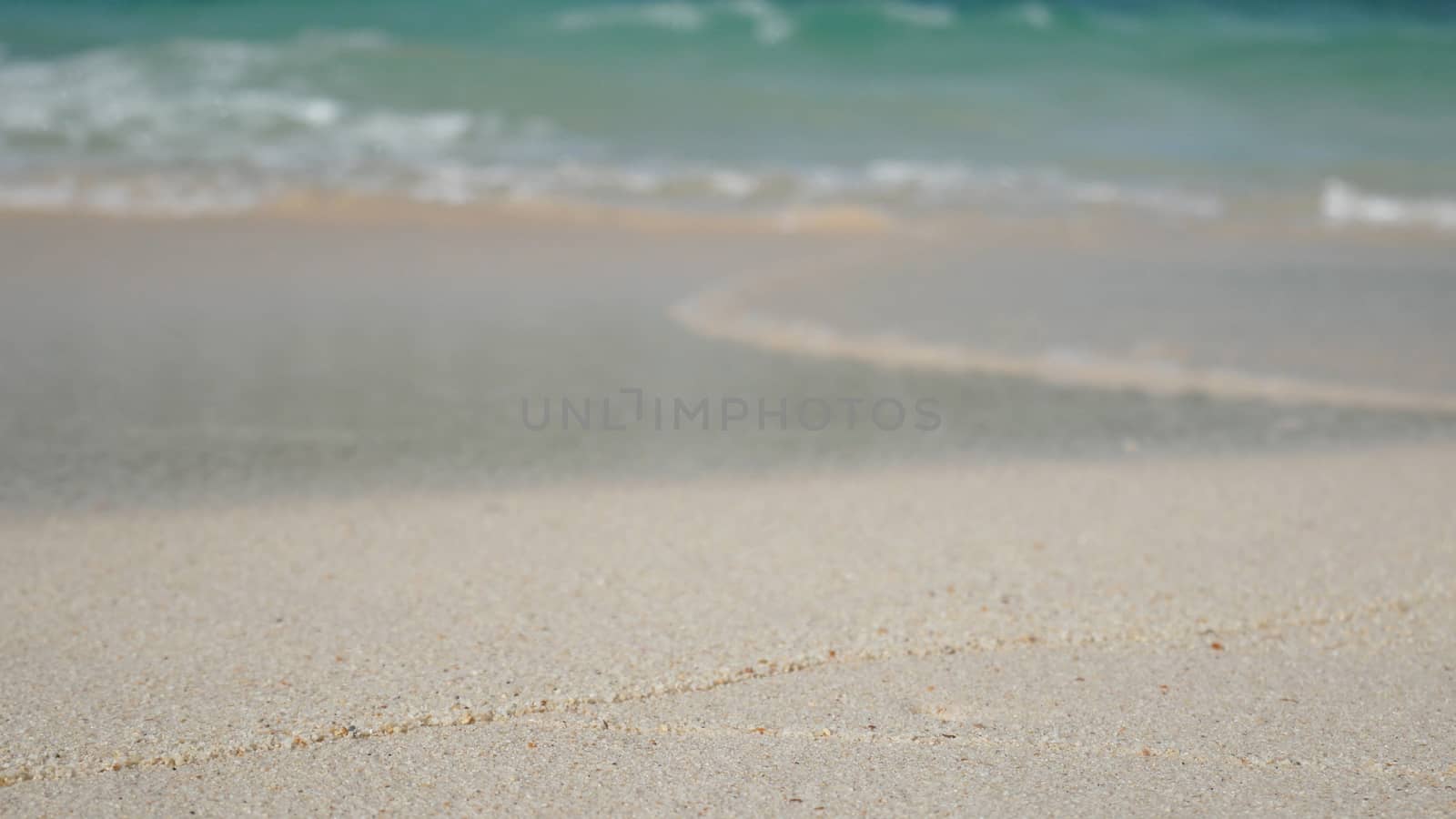 soft wave of blue ocean on sandy white beach. summer background.