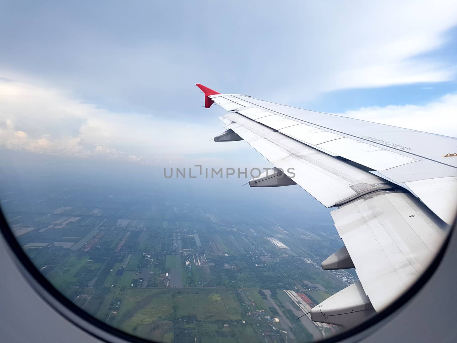 city view clouds and sky as seen through window of an aircraft. travel and vacation concept