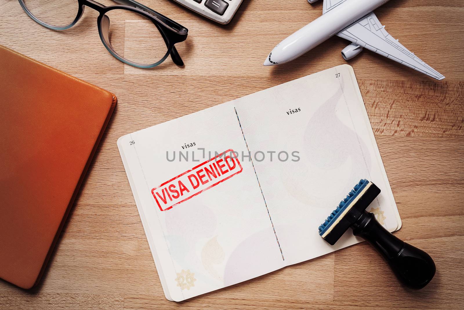 visa and passport with denied stamp on a document top view in immigration. travel immigration stamp and tourism concept