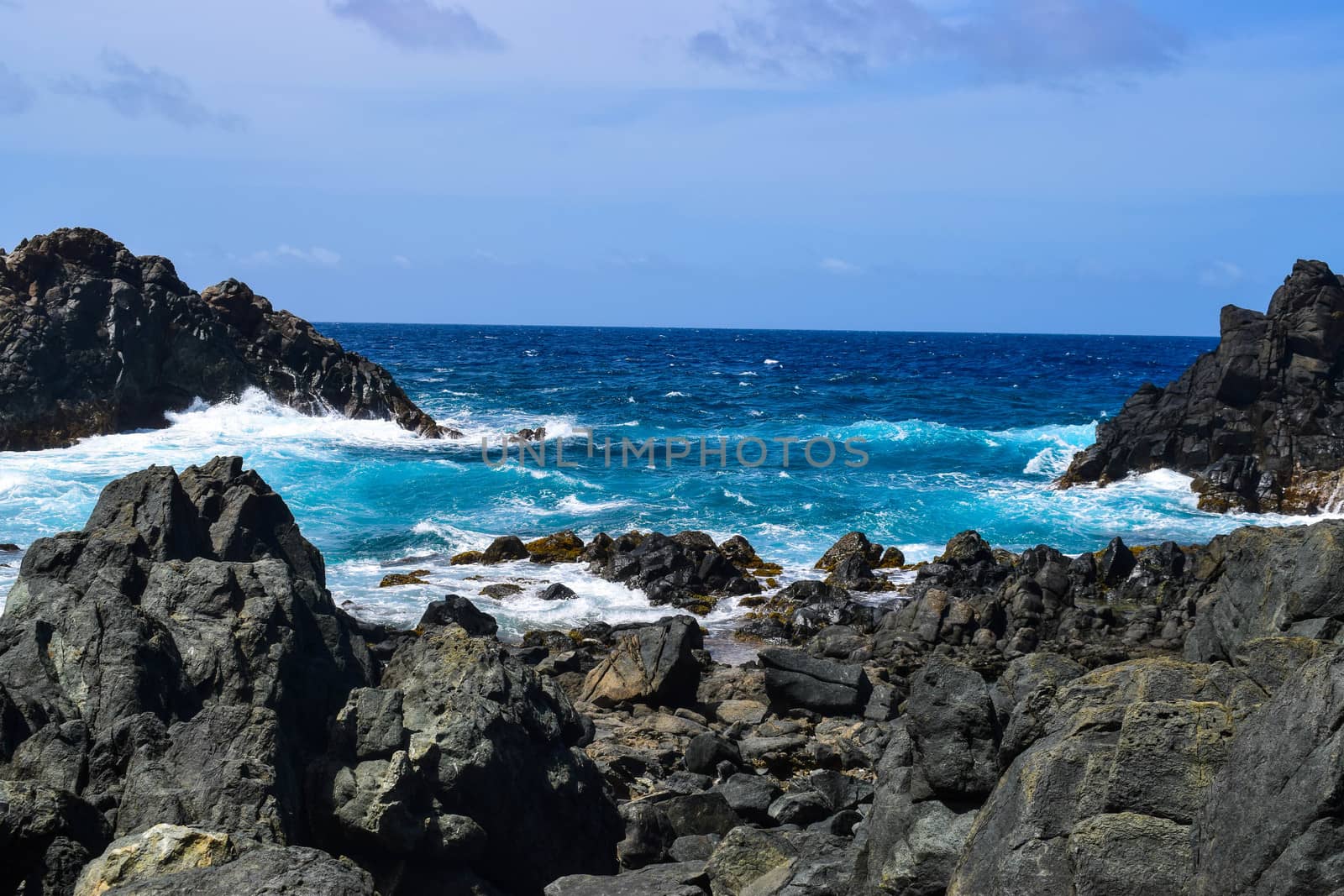 Arikok Natural Park on the island of Aruba in the Caribbean Sea with deserts and ocean waves on the rocky coast