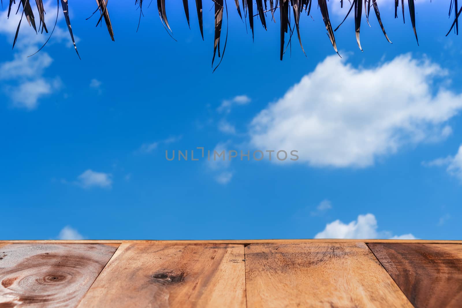 Selective focus of old wood table with blue sky background for display your product.