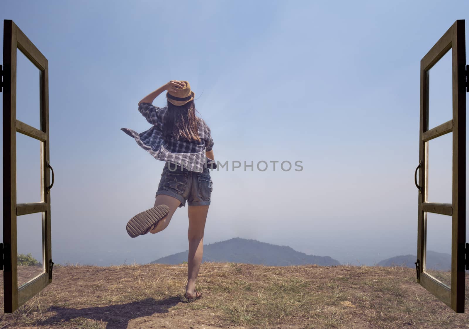 Asian woman jump out from open door to mountain top view with exciting feeling, explore travel discovery concept