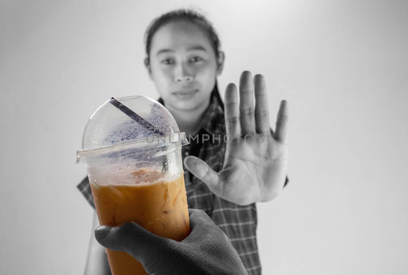 Asian young woman refuse Iced Thai milk tea, Healthy lifestyle and diet concept.