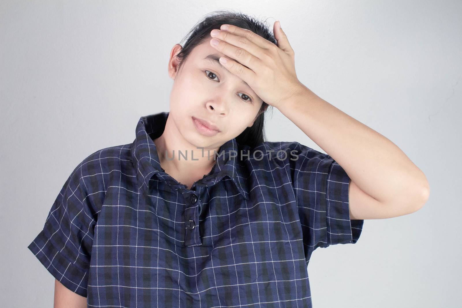 Asian young woman holding hand on forehead, suffering from feeling bad and sick. Health care concept.