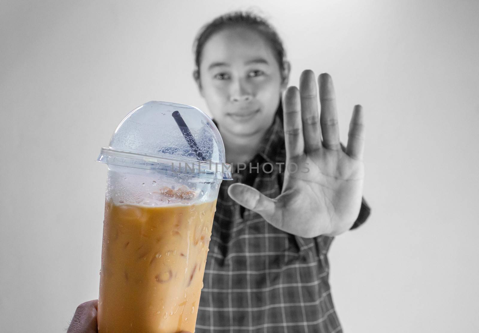 Asian young woman refuse Iced Thai milk tea, Healthy lifestyle and diet concept. by TEERASAK