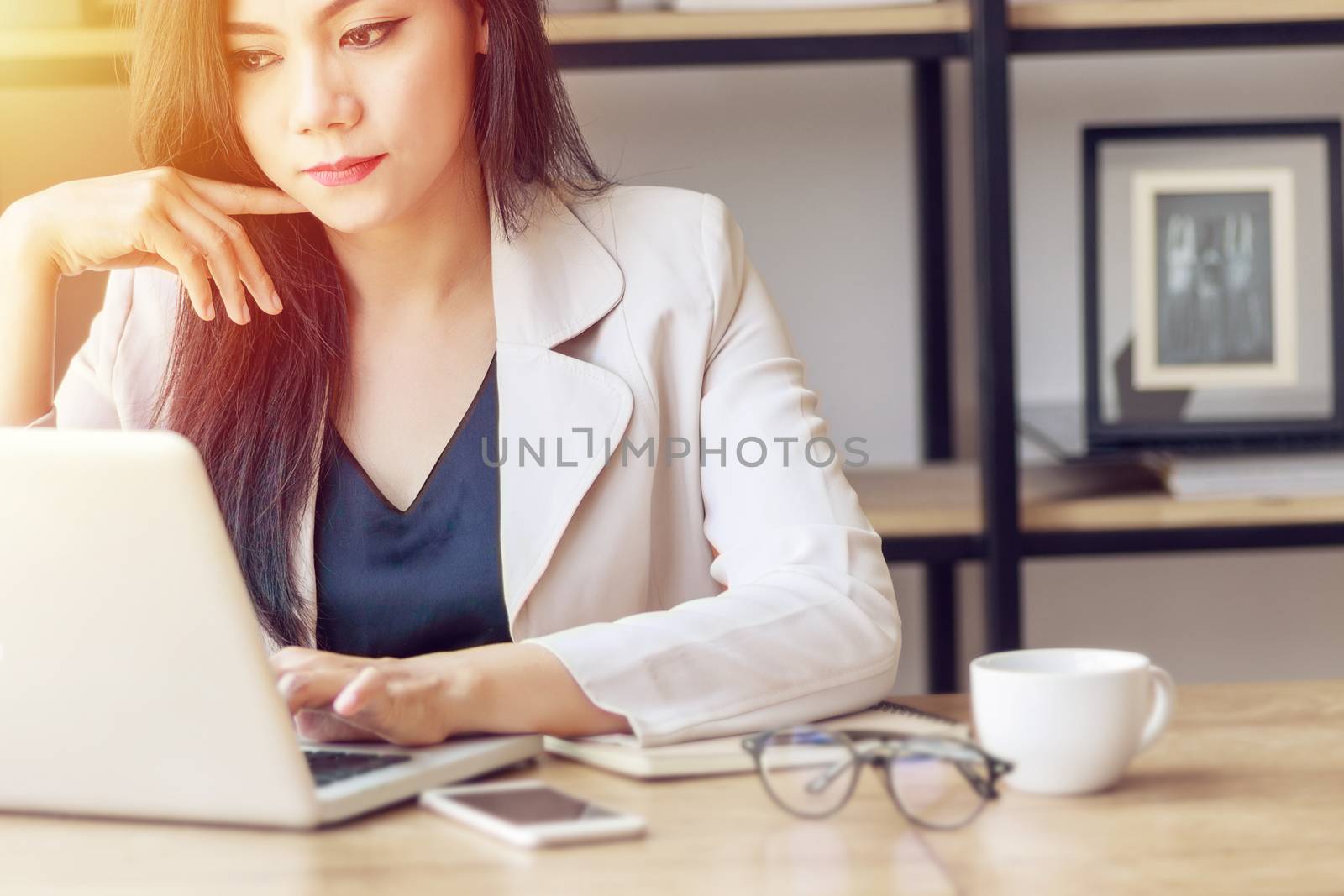 young Asian business woman at work. beautiful Asian woman in casual suit working with computer laptop in modern office. freelance and start up business in Asia concept by asiandelight