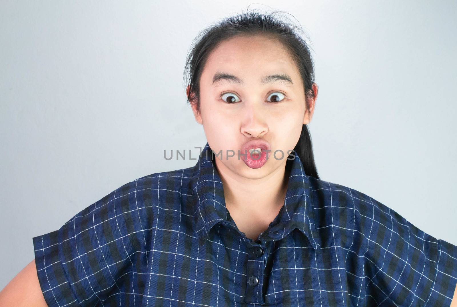 Asian young woman in blue shirt, Make funny faces for you to be happy and not stressed. Body language and encouragement concept.