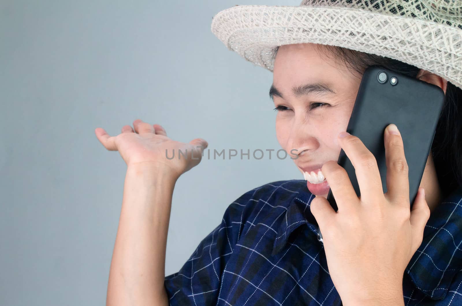 Asian young woman smiling while talking on phone in vacation day, Isolated on grey background.