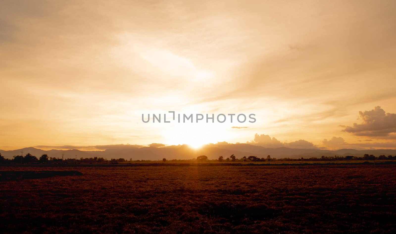 Landscape of mountain with sunlight through the large cloud in r by TEERASAK