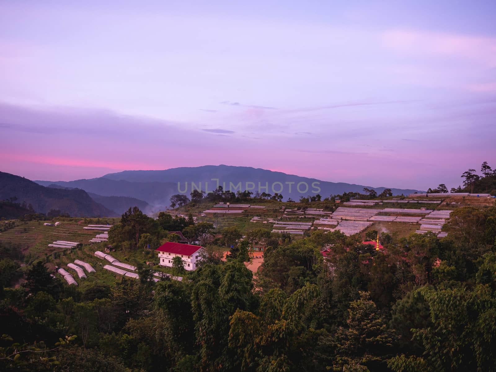 Landscape of agricultural areas of people in Fang district, Chiang Mai, Thailand from the top of the mountain in the evening on sunset background.