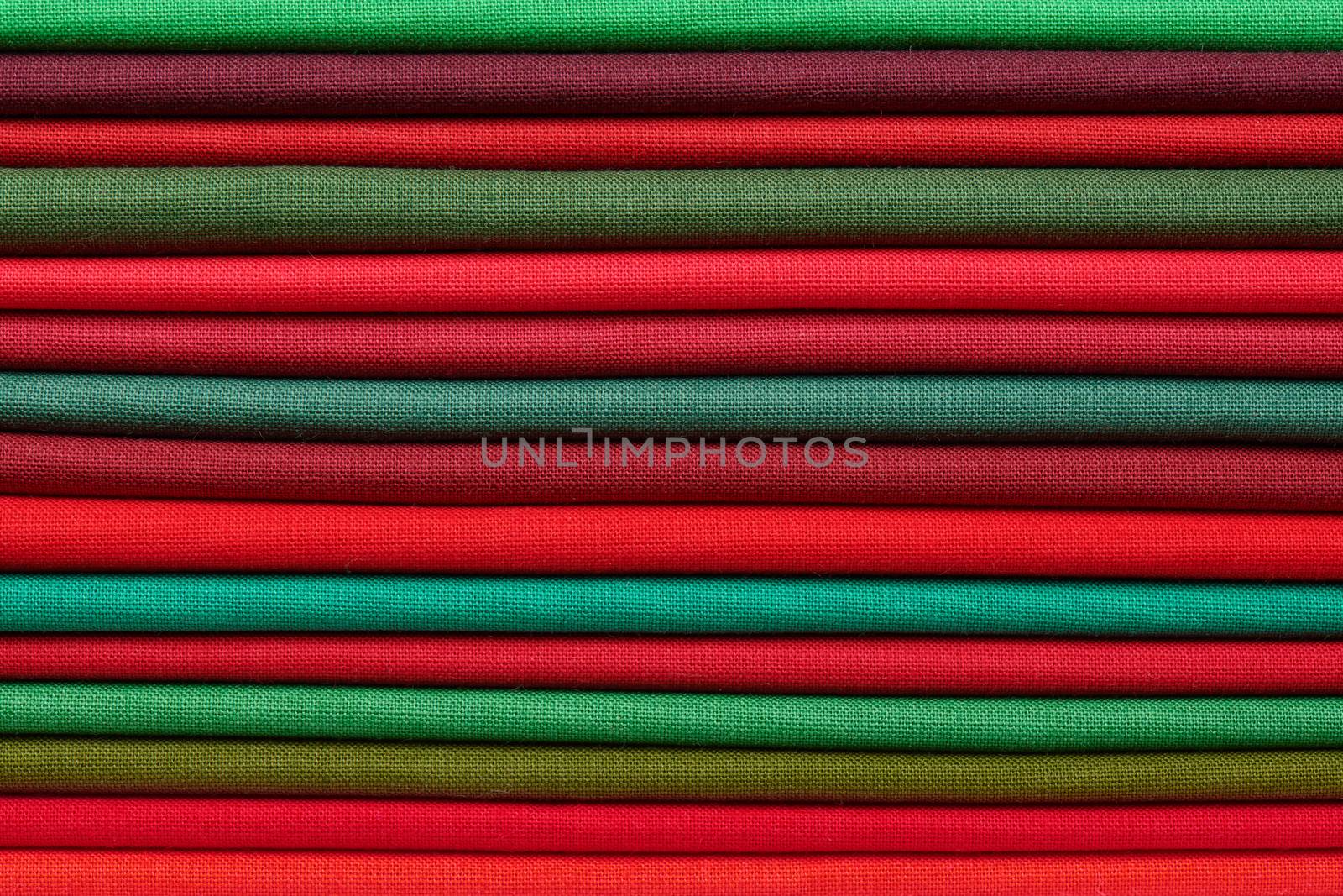 Stack of red and green fabrics as a vibrant background image