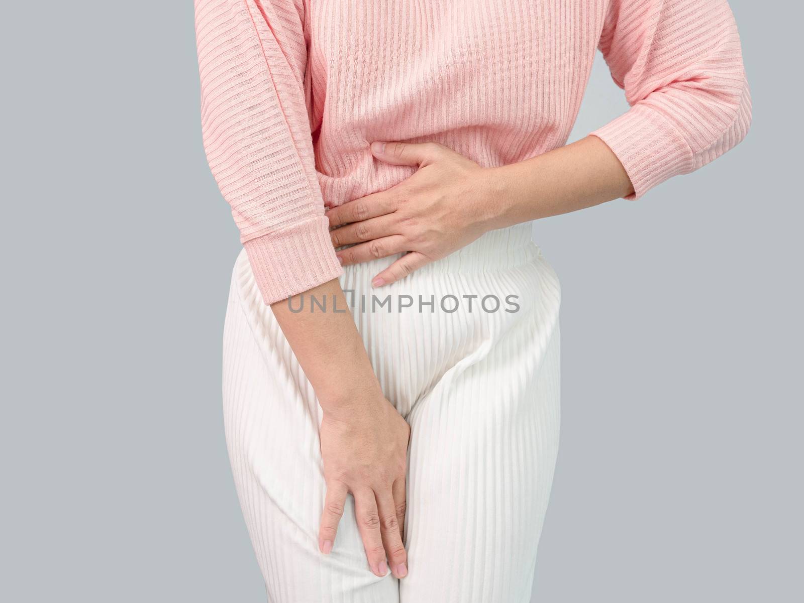 Unhealthy Asian women suffer from abdominal pain, irregular menstruation, isolated on a grey background. by TEERASAK