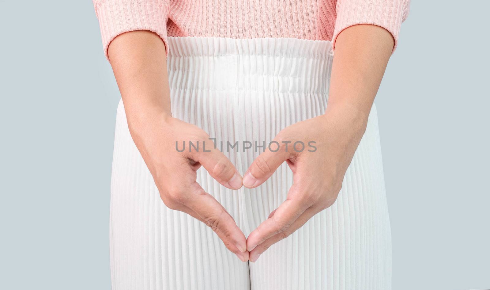 Close up view of young woman and Hand is a symbol of heart over her crotch. Feminine hygiene concept. by TEERASAK