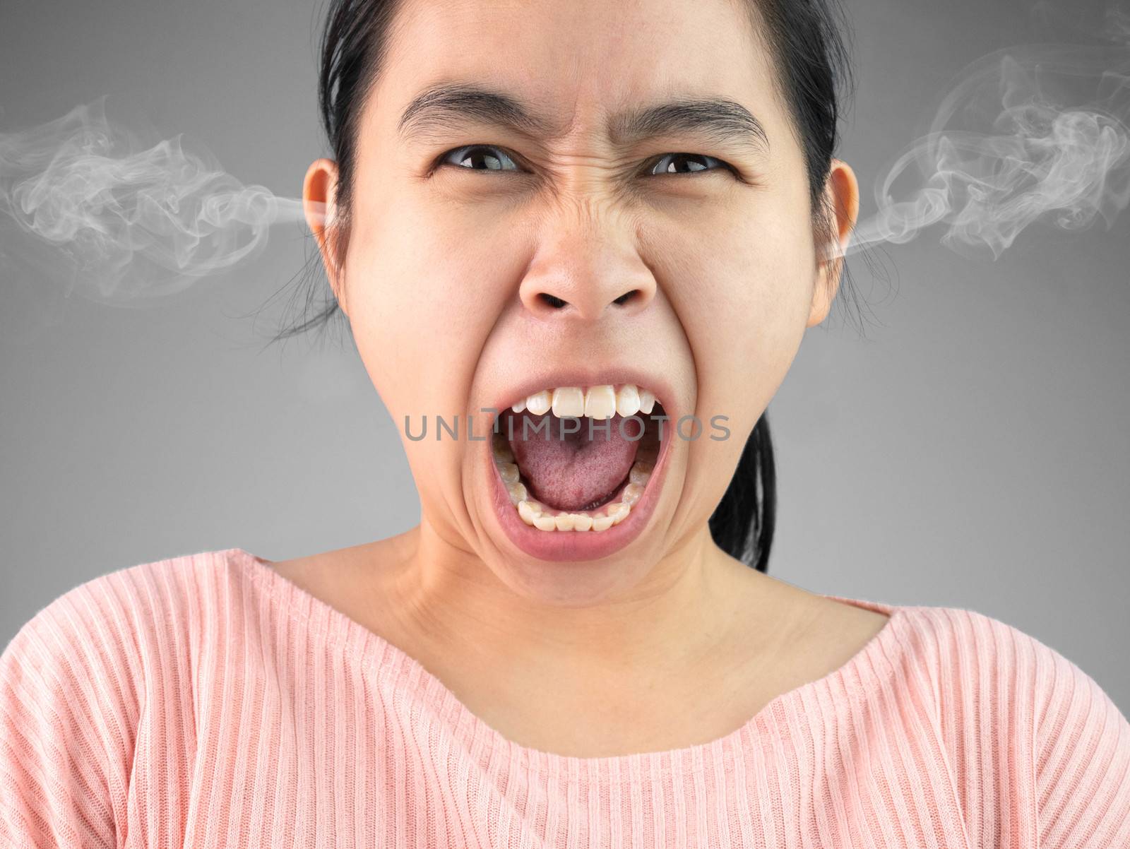 Furious and frustrated woman yelling and steaming with rage. Emotional and expression concept.