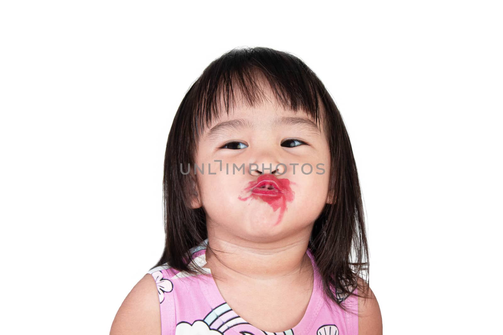 Adorable asian little girl making kiss with mess lipstick all over mouth. learning activity to be a beautiful woman.