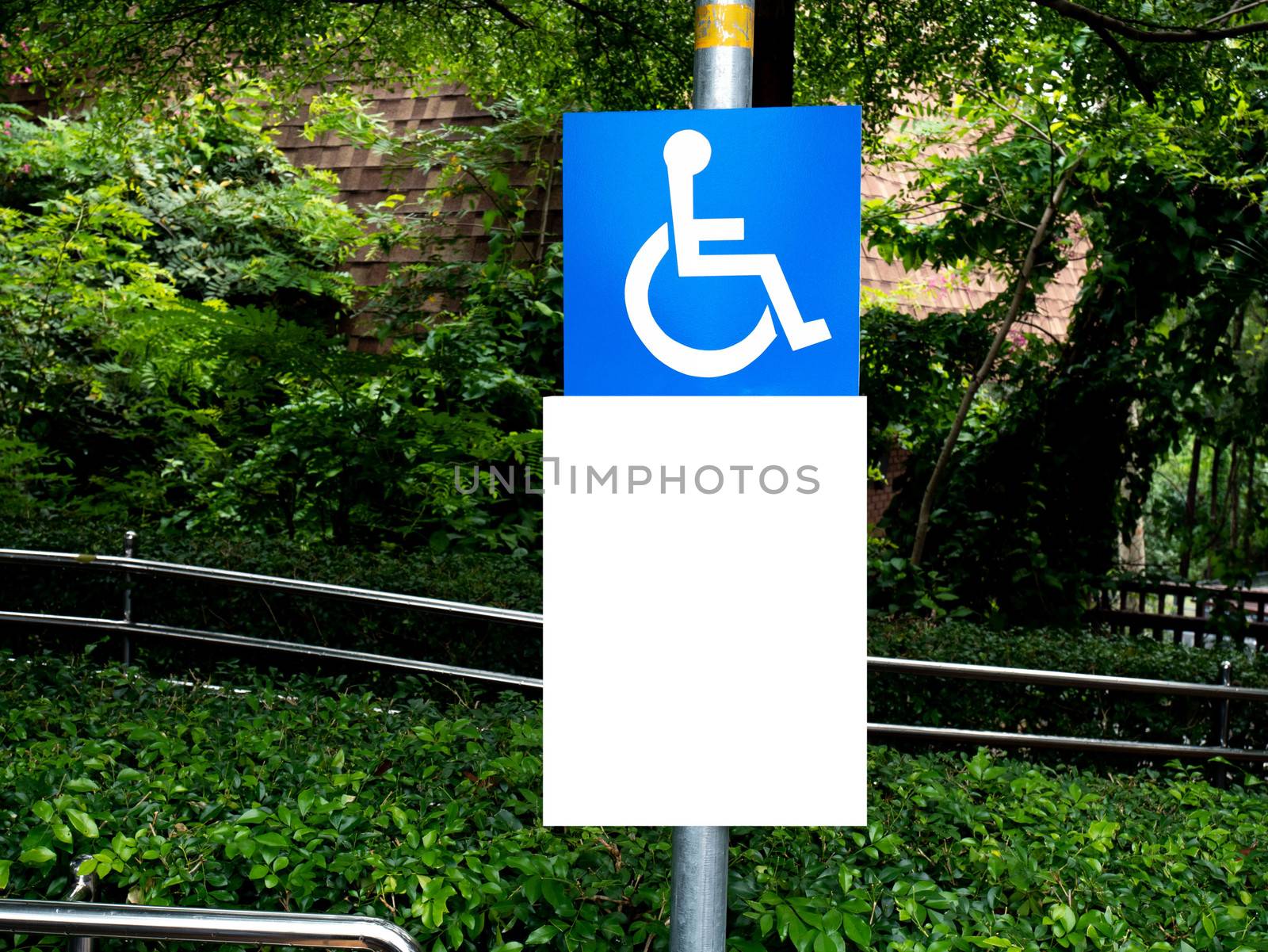 Disabled wheelchair sign at Concrete ramp way in the park. by TEERASAK