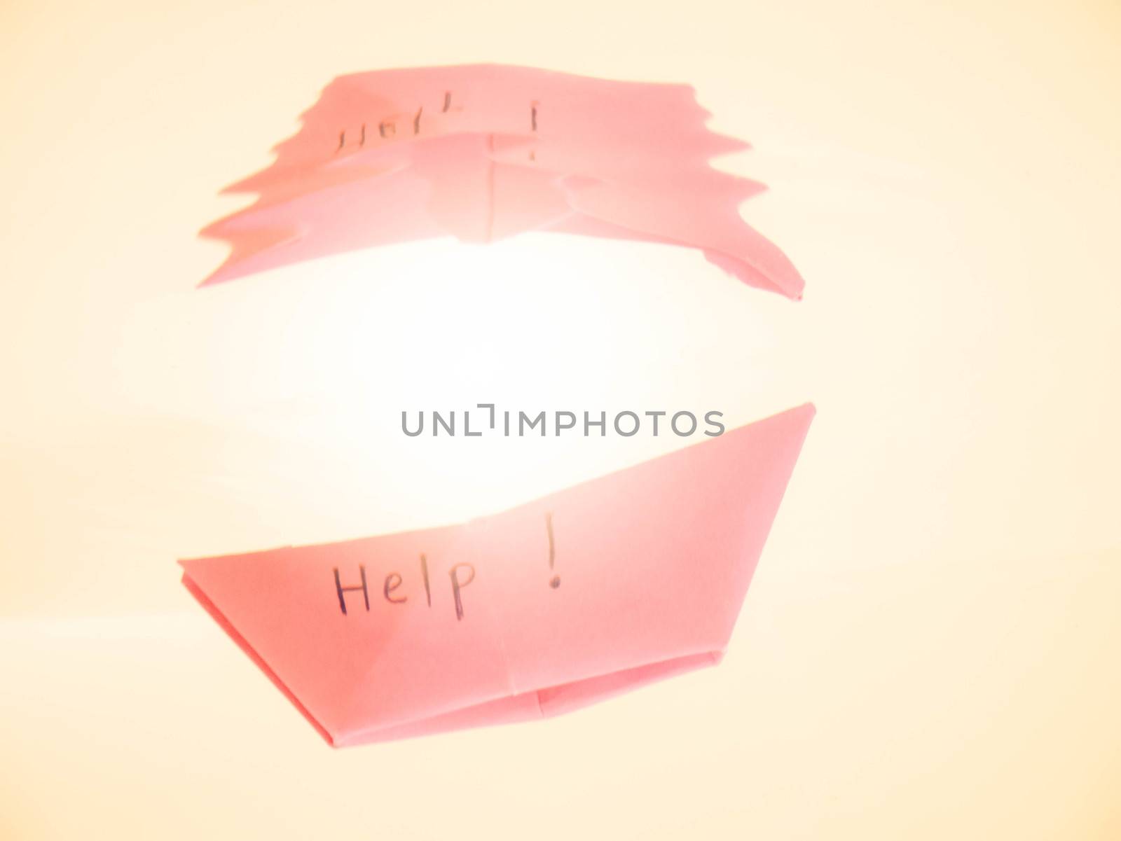 Close-up of sinking folded paper boat into the water. Mental state and Emotional concept.