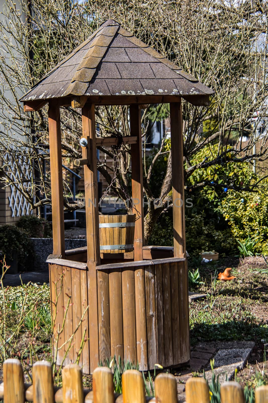 wooden fountain with roof in the garden