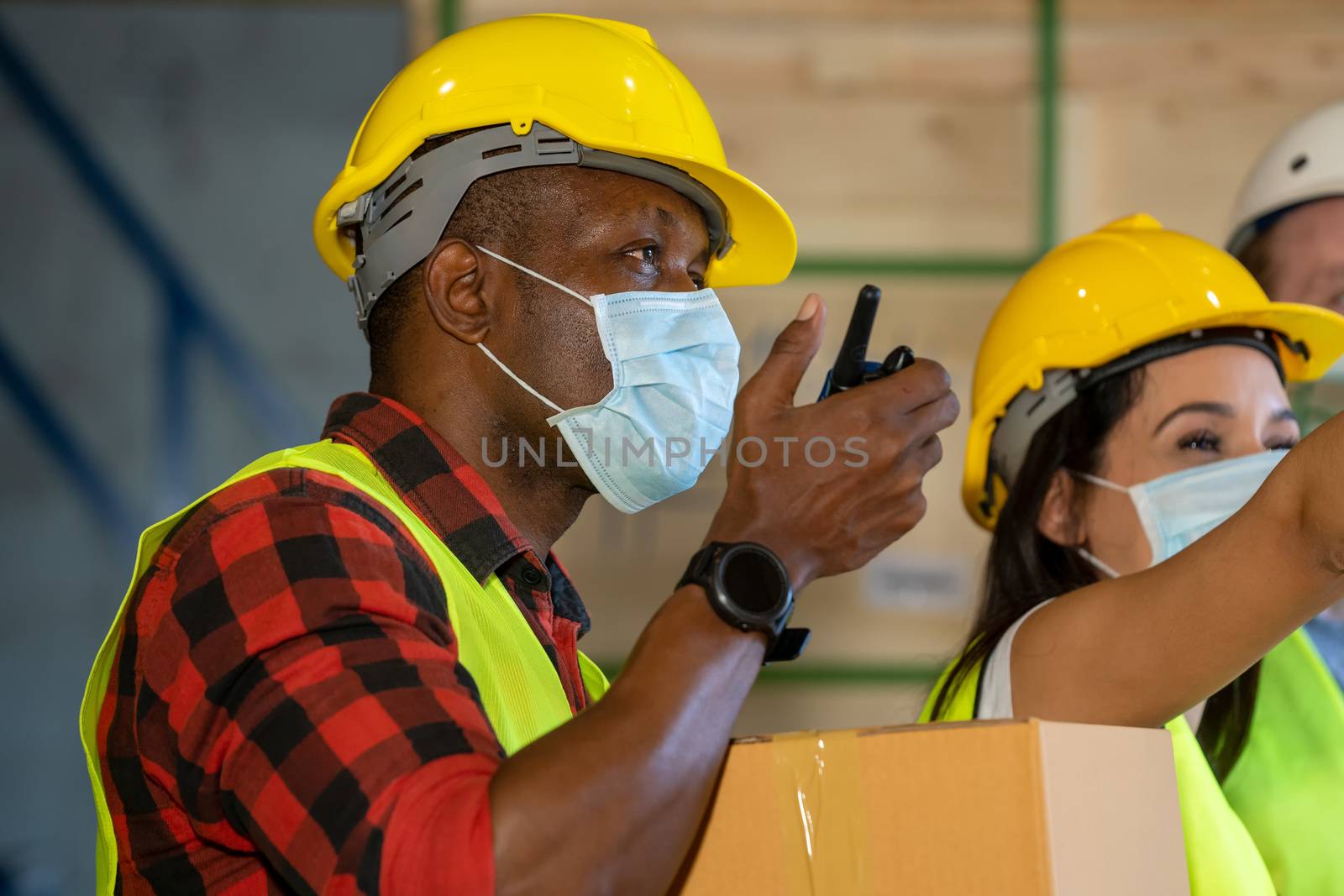 Warehouse workers wearing protective mask to Protect Against Covid-19 working at warehouse,They Work in Industry Manufacturing Factory.