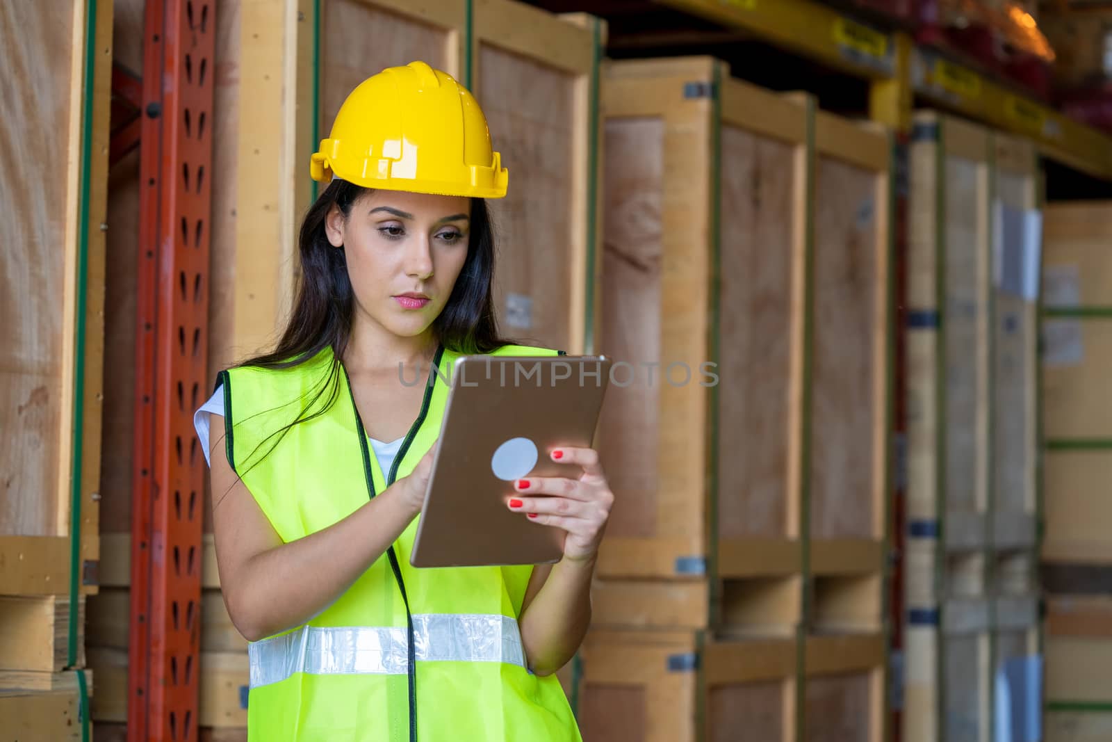 Female technician worker use laptop and Inspect the products in a large warehouse.