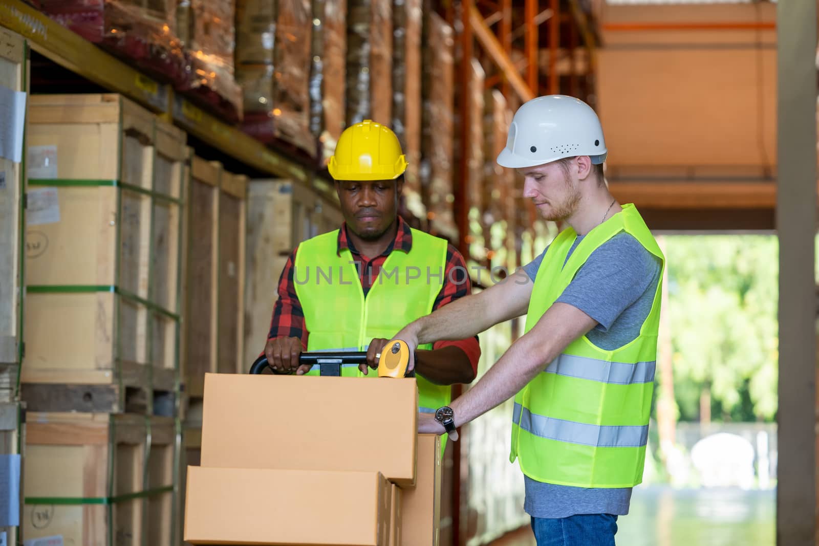 Warehouse worker loading or unloading boxes at warehouse,Logistics concept.