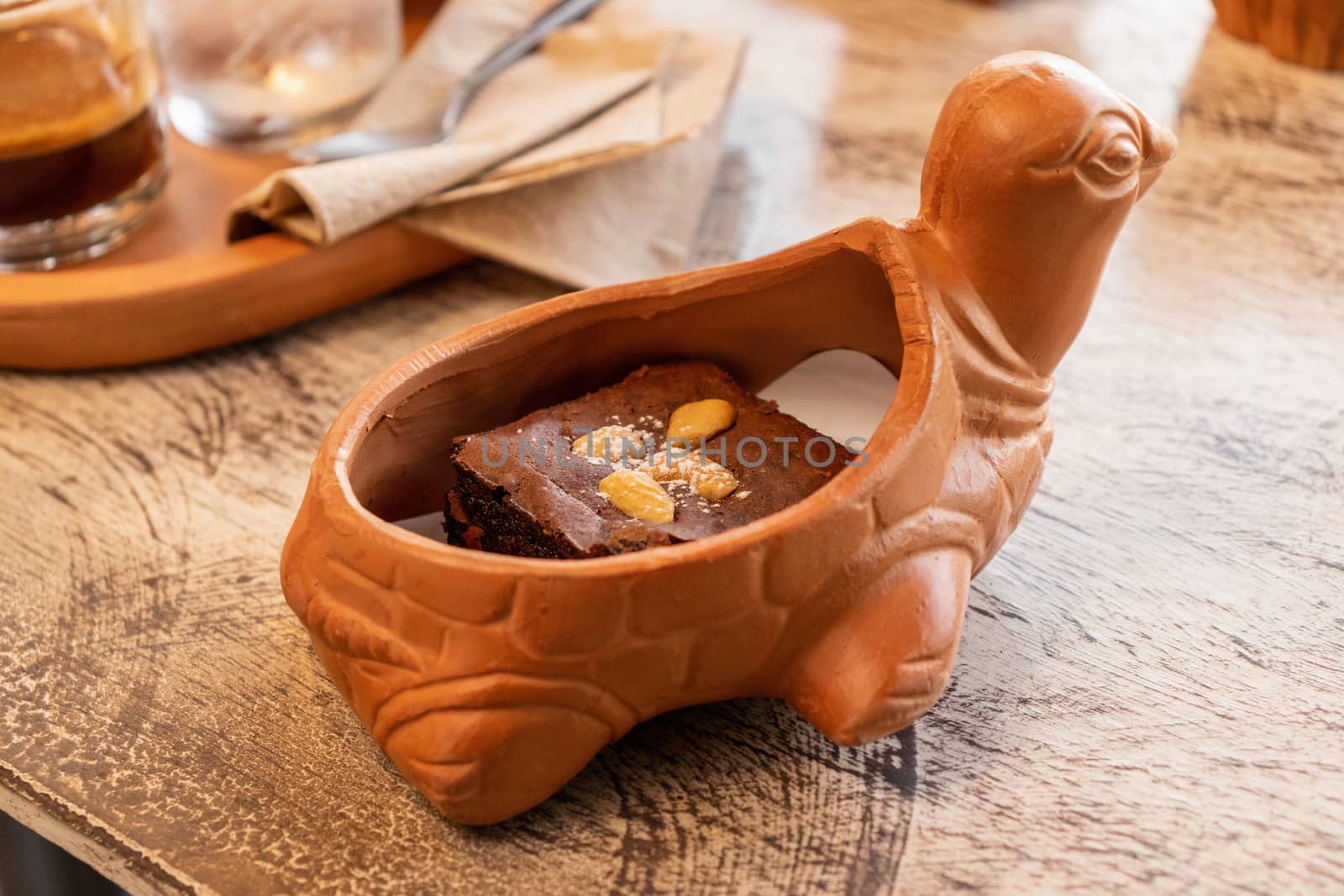 brawny cake served in earthen ware on the table