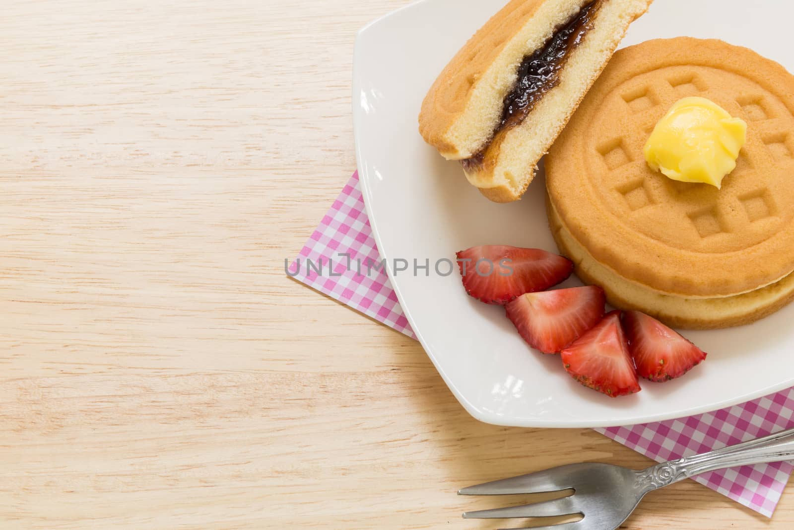 Background of waffle and tea on wooden table for tea break or coffee break.