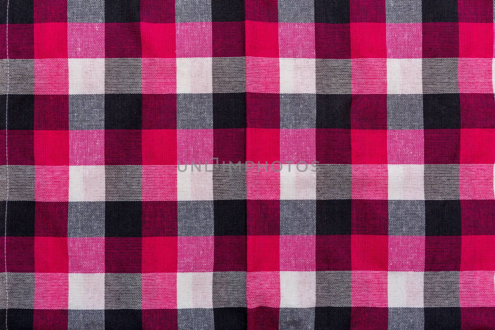 Tablecloth with square pattern with red, white, and black.