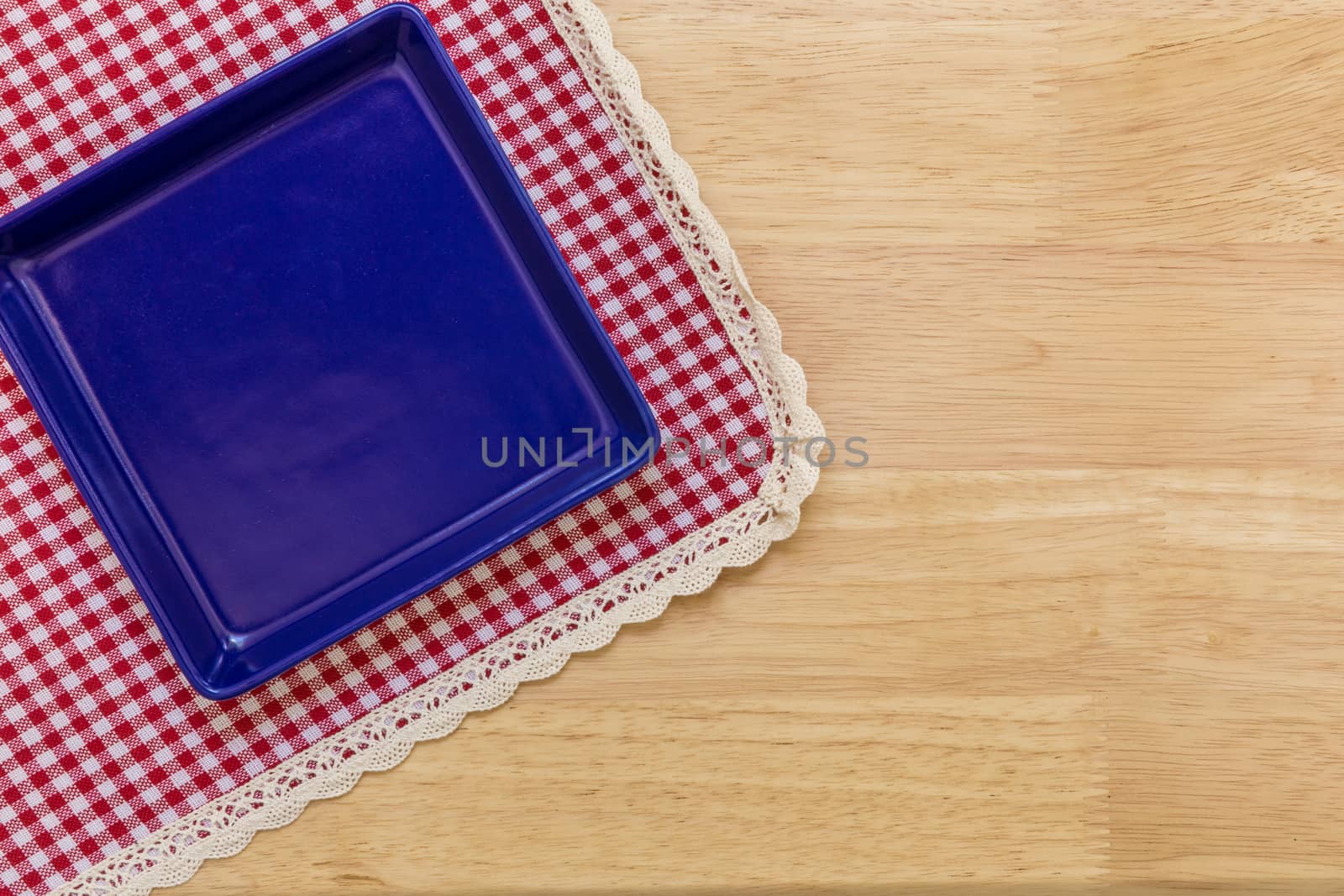 Empty plate without spoon and fork on table background.